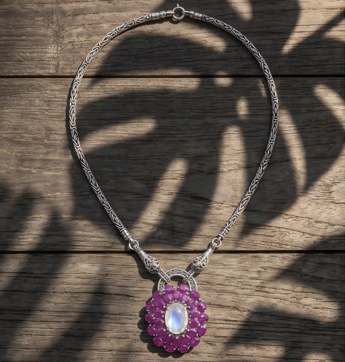 Isabella - Rare finding- 17.9 carat Rose Quartz Ruby .925 Sterling Silver handcrafted Statement Necklace - Necklace on wood, front view of pendant with rose quartz and rubies.