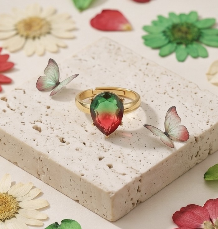 8.8 carat Brazilian Tourmaline .925 Sterling Silver dipped in 18K Gold Perfectly handcrafted Ring s. 8 adjustable - Close-up of 8.8 ct Brazilian Tourmaline ring on textured block with flowers.