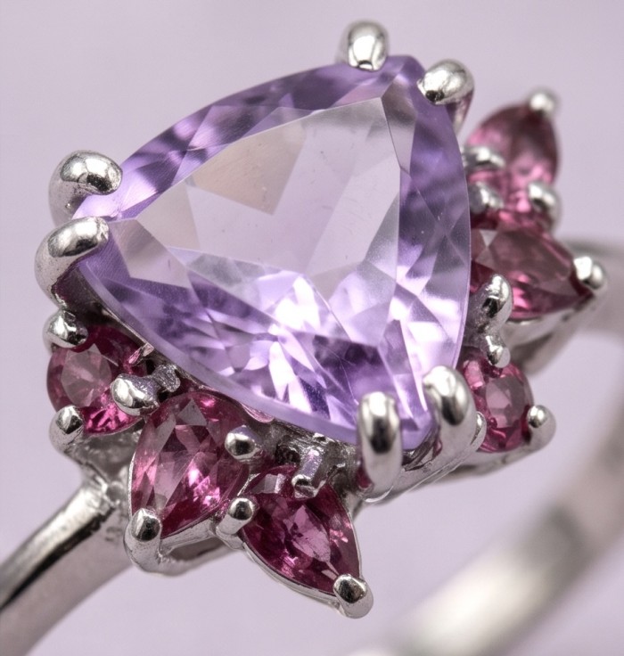 3.9 carat Amethyst rhodium over .925 Sterling Silver HUGE Ring s. 8 3/4 - Close-up of amethyst ring with pink accents on sterling silver band.