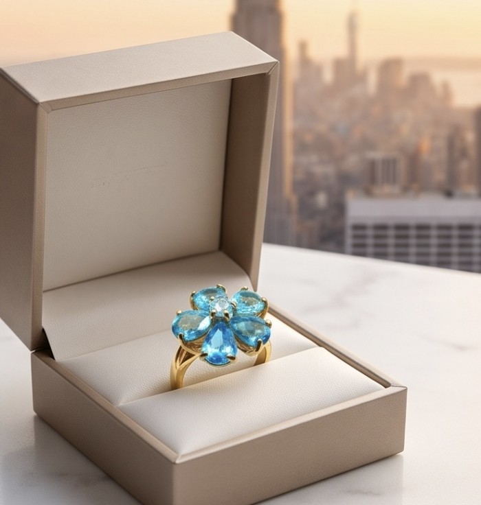 Forget -Me- Not Petal 6.5 carat genuine Swiss Blue Topaz 18K Gold over .925 Sterling Silver handmade Statement Ring size 8 - Top view of Swiss Blue Topaz ring in open box with city skyline background