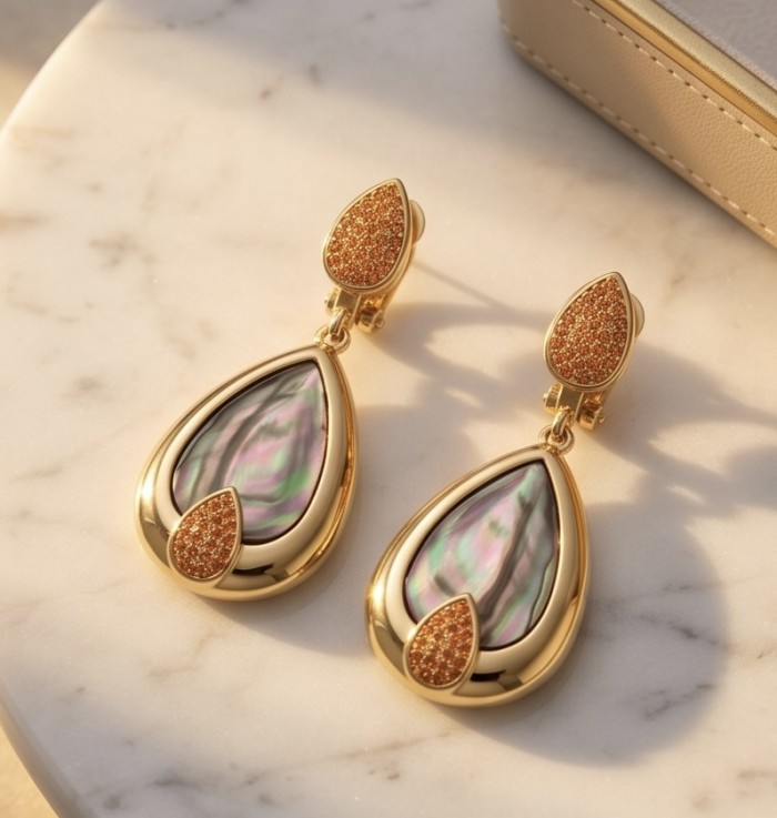 Blue Genuine Rainbow Abalone 18K Gold over .925 Sterling Silver handcrafted Statement Earrings - Drop earrings with abalone and gold, angled view on marble background.
