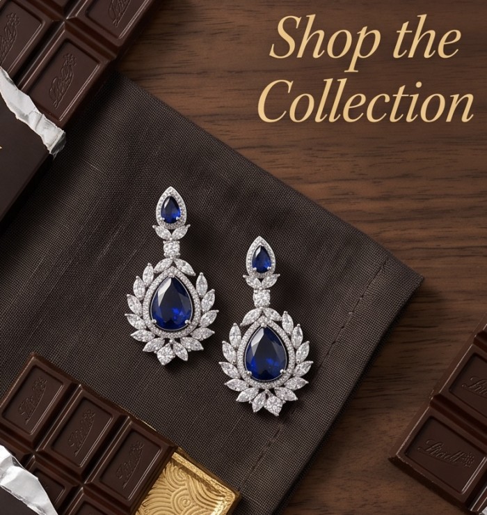 Vintage style - Giovanna - Authentic pear cut 8.9 carat Sapphire .925 Sterling Silver handcrafted earrings - Close-up of vintage style sapphire earrings on brown fabric and chocolates