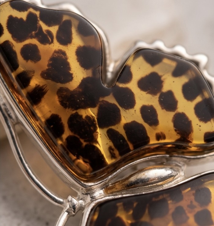 Butterflies carved Baltic Polish Amber rhodium over .925 Sterling Silver handcrafted earrings - Close-up of butterfly-shaped amber jewelry with silver details