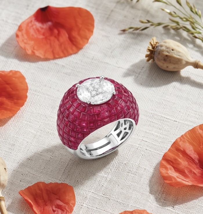 Scarlett 10.7 ctw Mozambique Ruby .925 Sterling Silver dipped in 18K WHITE Gold handcrafted Statement Ring size 8 - Ruby ring on fabric with flower petals, top view.