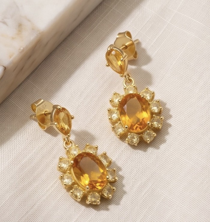 Giovanna - Authentic 4.4 carat Brazilian Citrine .925 Sterling Silver dipped in 22K Gold handcrafted earrings - Close-up of gold citrine earrings on fabric background.