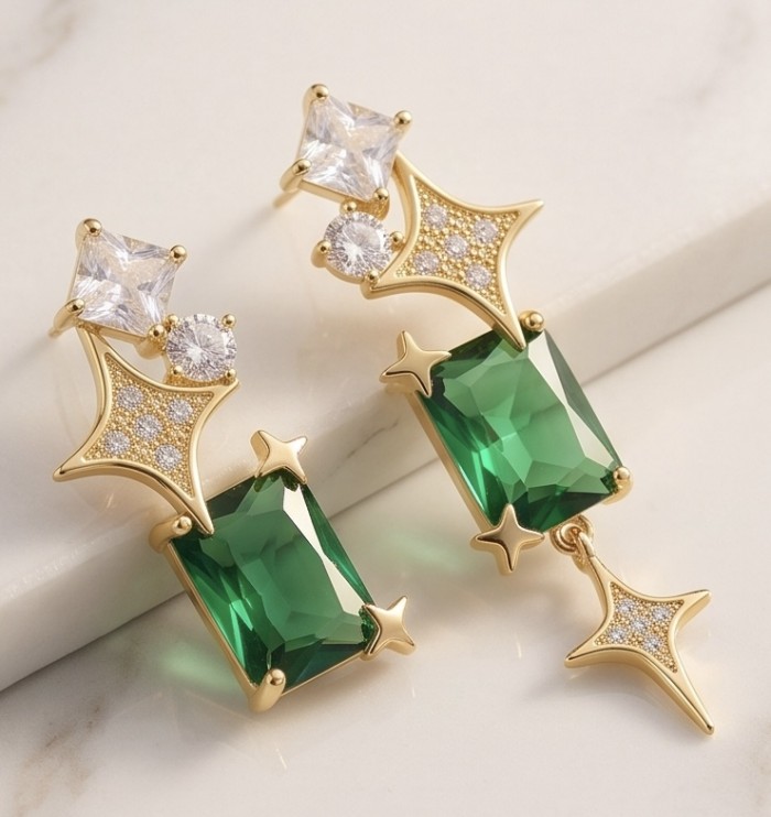 Green Dreamland 9.9 carat authentic Himalayan Peridot .925 Sterling Silver Handcrafted Asymmetrical Statement Earrings - Close-up of gold earrings with green and clear stones on marble surface.