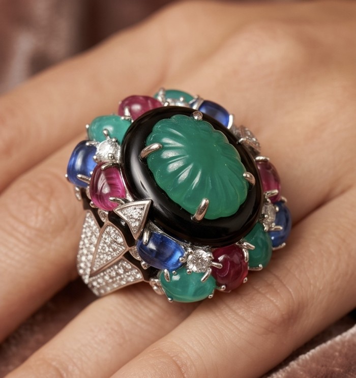 Iconic design - Natural 41.5 carat carved Emerald Ruby Sapphire rhodium over .925 Sterling Silver handcrafted ring size 7 1/4 - Worn on hand, close-up of carved emerald with rubies and sapphires.