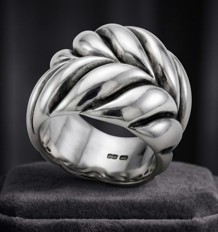 Mantra Solid Bali made .925 Sterling Silver ring size 7 1/2 - Front view of Mantra .925 Sterling Silver ring on a display cushion