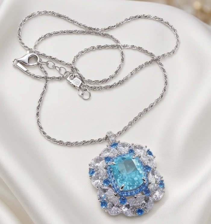 Mademoiselle - 21.5 carat natural Swiss Blue Topaz .925 Sterling Silver dipped in Rhodium handcrafted Necklace - Topaz pendant necklace on satin; close-up of stone and silver chain