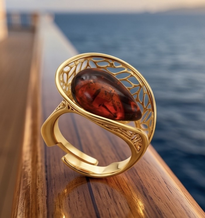 Authentic Baltic Amber 14K Gold over .925 Sterling Silver handcrafted ring; s. 7 adjustable - Amber ring in gold setting, angled view on wooden surface by the sea
