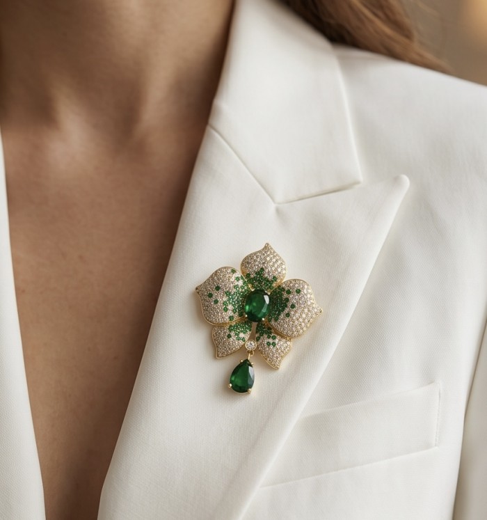 Heirloom Genuine 18.5 carat Colombian Emerald .925 Sterling Silver handmade Brooch - Emerald brooch on white jacket, front view, detailed and elegant design