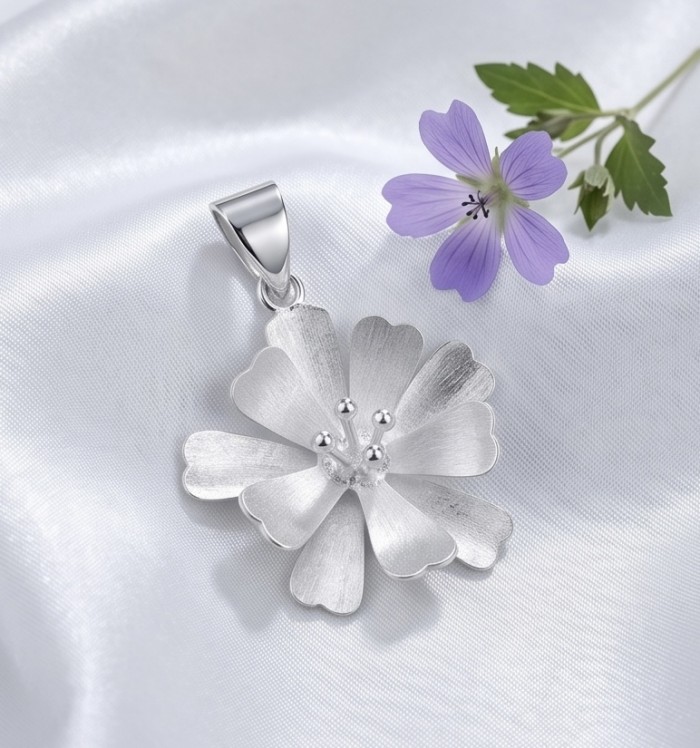 Silver Flower Design .925 Sterling Silver handmade Pendant - Silver flower pendant displayed on satin with purple flower detail.