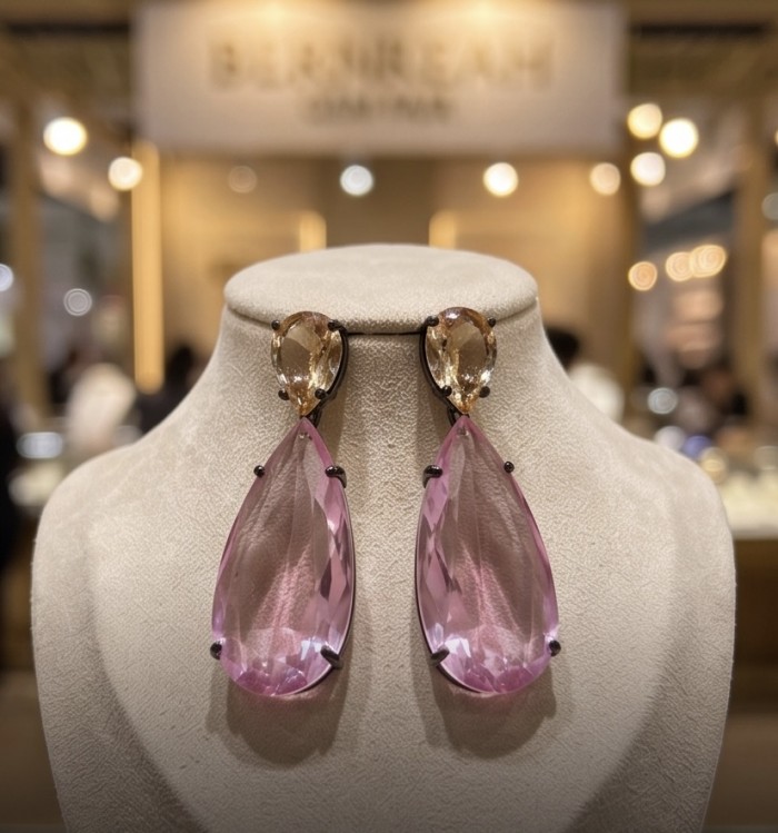 Victoria- authentic pear cut 12.7 carat Pink Topaz .925 Sterling Silver dipped in black rhodium handcrafted Earrings - Front view of pink topaz earrings on display stand