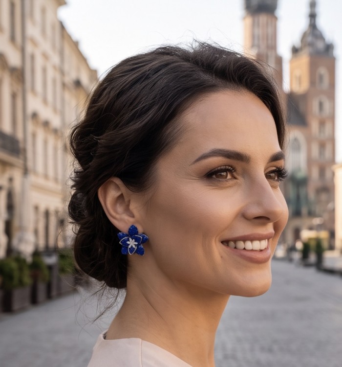 Born to Glam authentic mystery setting 18.2 carat Colombian Sapphire .925 Sterling Silver handcrafted earrings - Side view showing earrings worn by a woman in an outdoor setting.