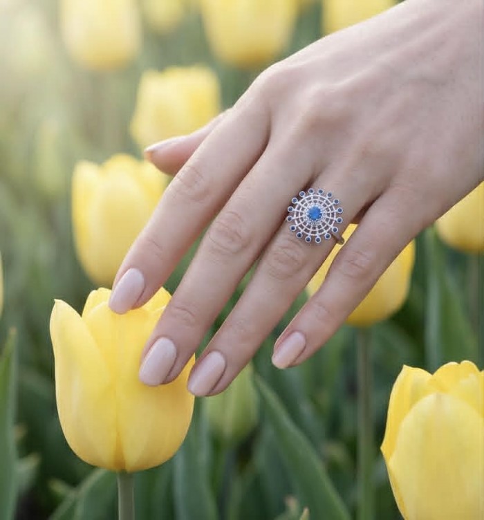 Star 2.2 carat natural Sapphire .925 Sterling Silver Perfectly handcrafted Ring s. 7 - Sapphire ring on hand among yellow tulips, top view.