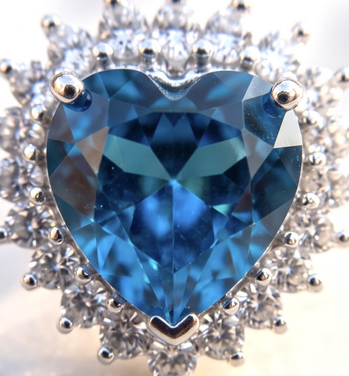 Heartes 6.7 carat Swiss Blue Topaz .925 Sterling Silver Handcrafted earrings - Close-up of Heartes Swiss Blue Topaz with silver setting detail.