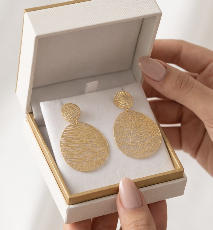 Dubai Style - .925 Sterling Silver dipped in 22K Gold handmade Earrings - Gold teardrop earrings in box, top view, held by hands with manicured nails.