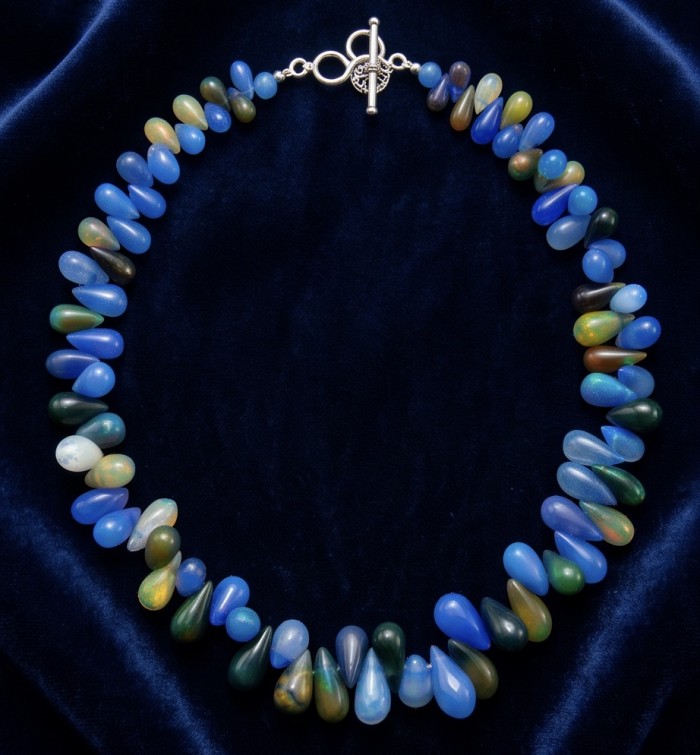 Sublime Brilliance Authentic Black Opal .925 Sterling Silver handcrafted bracelet - Black opal necklace with clasp detail on velvet background.