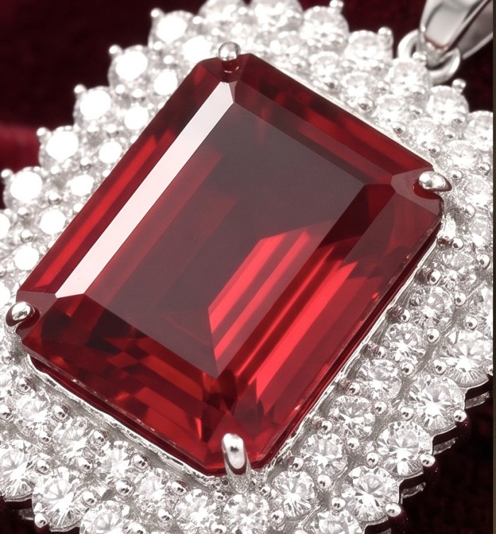 Rare finding! Deluxe 51.2 carat authentic emerald cut Kashmir Ruby rhodium over .925 Sterling Silver handmade Statement Pendant - Close-up of a deluxe emerald cut red gemstone surrounded by diamonds.