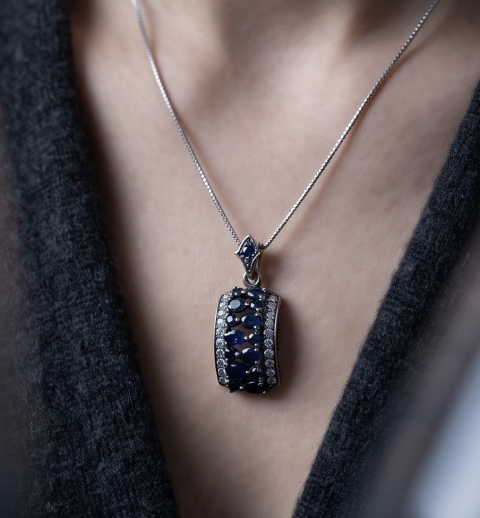 Vintage Beauty 9.7 carat Mozambique Sapphire Black Rhodium over .925 Sterling Silver handcrafted pendant - Sapphire pendant necklace worn on neck, close-up view.