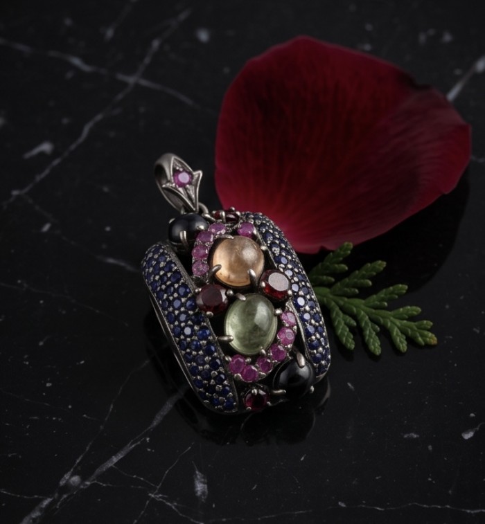 Stella 17.5 carat Brazilian Watermalon Tourmaline black rhodium over .925 Sterling Silver handmade Pendant - Front view of Stella pendant with colorful gemstones on black surface