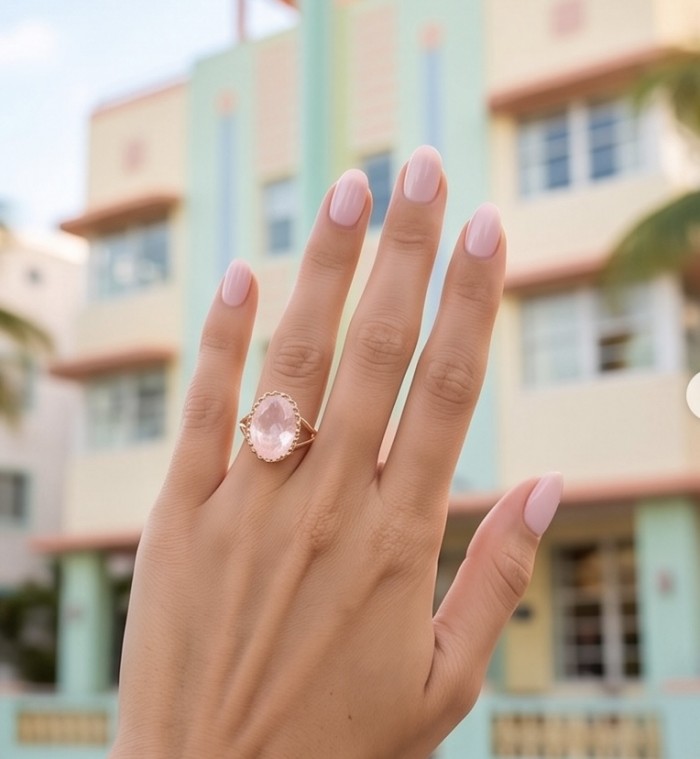 Top quality 22.2 carat Brazilian Rose Quartz .925 Sterling Silver dipped in 18K Gold Handcrafted Ring size 10 1/4 - Rose quartz ring worn on hand, pastel building in background.