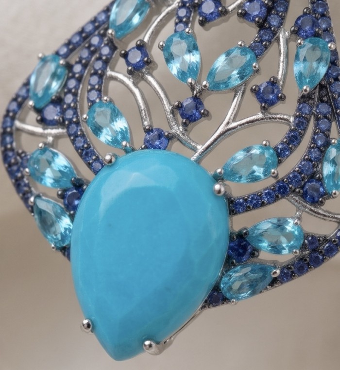 Pacifica - 14.4 carat Sleeping Beauty Turquoise 4.8 carat Swiss Blue Topaz .925 Sterling Silver handmade Statement Earrings - Close-up of Pacifica ring with turquoise and blue gemstones.