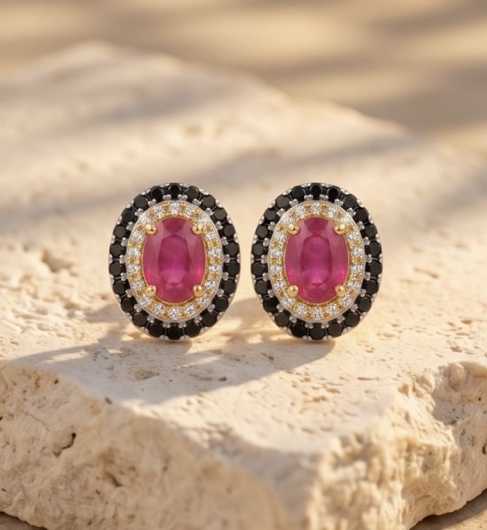 Born to Glam uthentic 3.2 carat Ruby 2 tones .925 Sterling Silver handcrafted earrings - Close-up of Born to Glam ruby earrings on a stone surface.