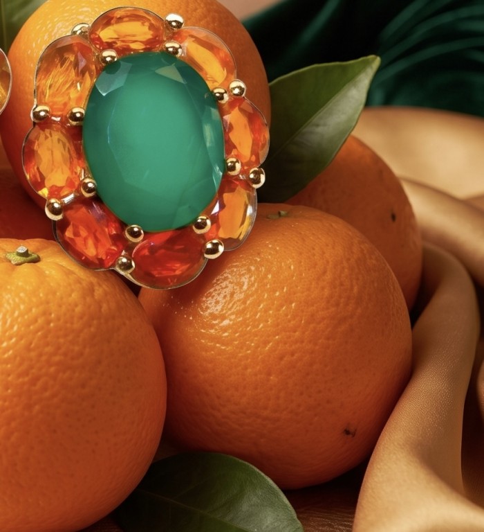 Giovanna - Authentic 4.5 CARAT natural Colombian Emerald .925 Sterling Silver handcrafted Statement earrings - Close-up of emerald ring with orange gems on oranges background