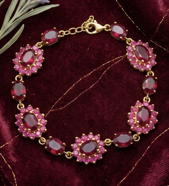 Bella Rosa - 29.4 carat authentic Mozambique Ruby .925 Sterling Silver dipped in 22K Gold handcrafted Bracelet - Bella Rosa bracelet, top view, showcasing intricate ruby design on velvet.