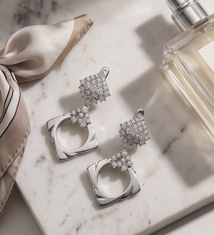 Allure Natural 8.2 carat White Topaz .925 Sterling Silver handcrafted hoop earrings - Allure earrings on marble with silk scarf and perfume bottle in view