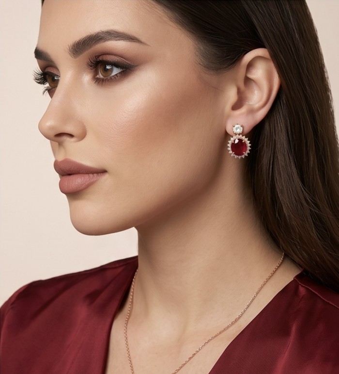 Exquisite 12.4 ctw Mozambique Ruby .925 Sterling Silver dipped in 22K Gold handcrafted Statement earrings - Side view of woman wearing Mozambique ruby earrings in silver setting.