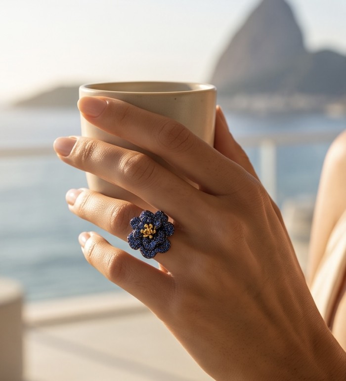 Blue Rose 22.5 carat Sapphire black rhodium over 18K Gold .925 Sterling Silver handcrafted ring size 8 1/2 - Blue rose sapphire ring worn on hand holding a cup, scenic background