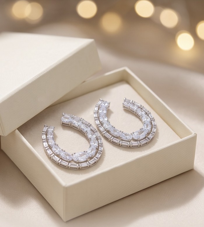 Elizabeth Natural 5.2 carat Moissanite .925 Sterling Silver handcrafted earrings - Moissanite earrings in a box, top view with bokeh lights background.