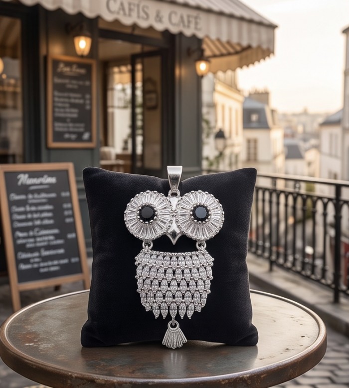Precious Owl - 12.5 CARAT Sapphire .925 Sterling Silver handcrafted pendant - Front view of Precious Owl pendant on display pillow in café setting