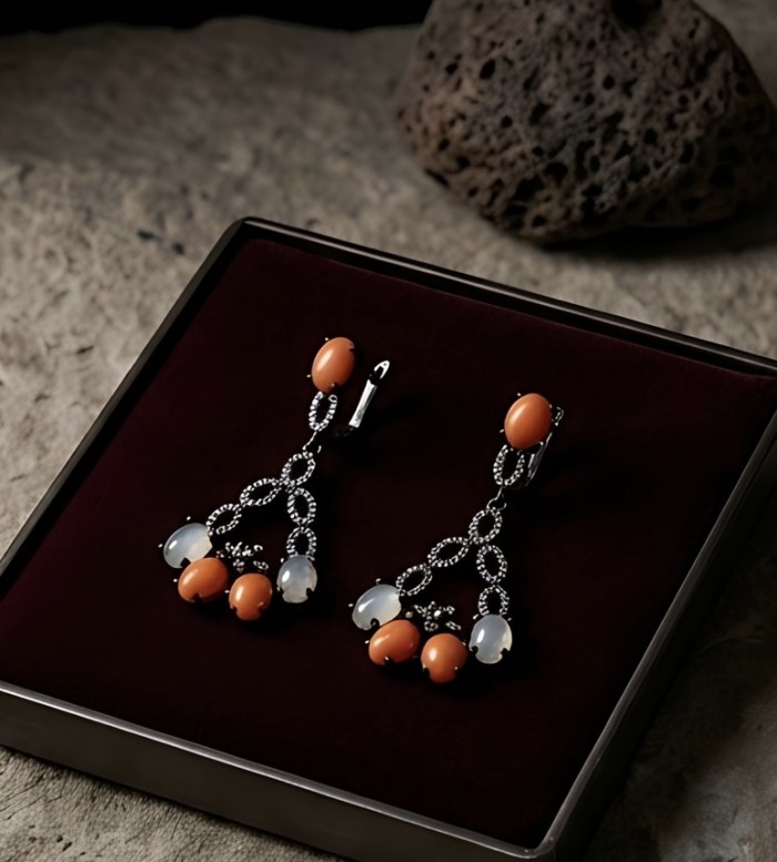Queen of the Sea Genuine Orange Fossilized Coral black rhodium over .925 Sterling Silver handmade earrings - Earrings on display; orange coral and black rhodium detail.