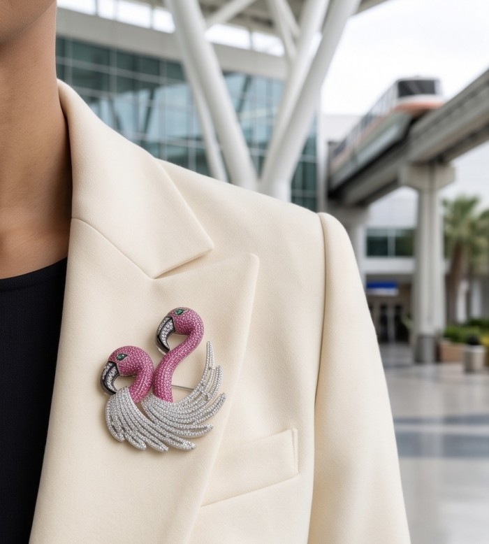 Pink Flamingo 5.7 pave Mozambique Ruby 1.8 carat Moissanite 0.4 carat Emerald .925 Sterling Silver dipped in rhodium handmade Brooch - Flamingo brooch with rubies, moissanite on cream blazer, front view.