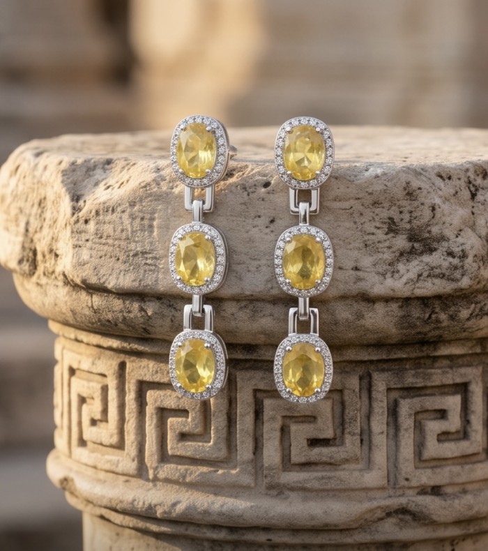 Luxurious - 24.4 carat Yellow Sapphire from Ceylon .925 Sterling Silver dipped in Rhodium handcrafted earrings - Dangling yellow sapphire earrings on stone background, front view