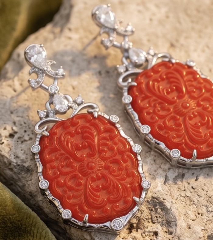 Ancient Mystery carved Fossilized Coral rhodium over .925 Sterling Silver handmade Statement Large earrings - Close-up of carved coral earrings with silver detailing.