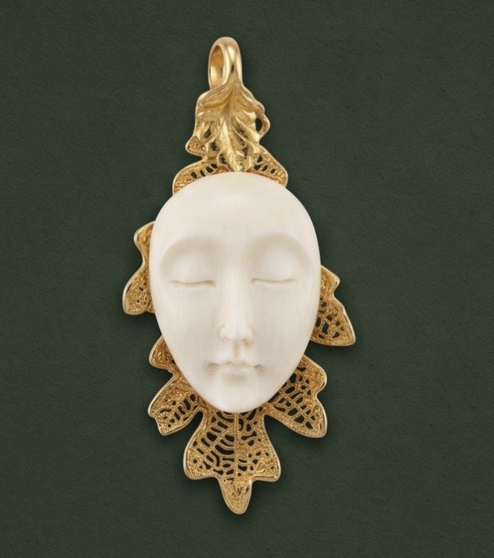 Stylish REAL Leaf dipped in Gold 10.5 carat carved Bone .925 Sterling Silver Pendant - Front view of gold-dipped leaf pendant with carved bone face.