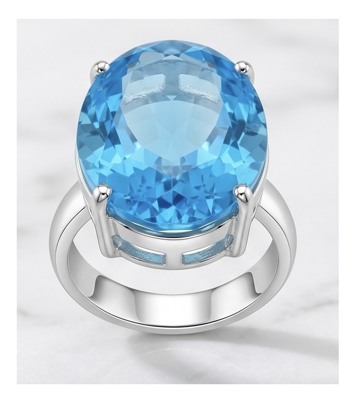 ENCHANTED OCEAN 28.3 carat Swiss Blue Topaz .925 Sterling Silver dipped in rhodium handcrafted Large ring size 8 - Close-up of ENCHANTED OCEAN Swiss Blue Topaz ring on a marble surface.