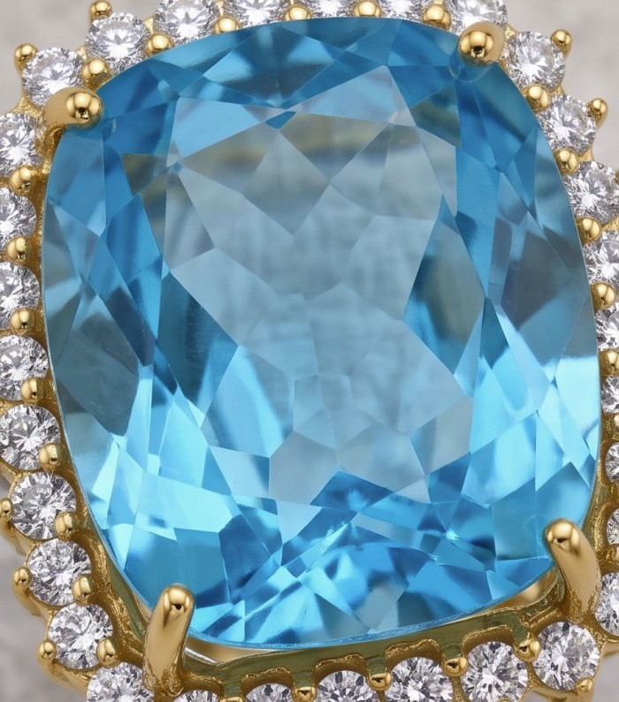The Ocean Empress 57.8 carat Swiss Blue Topaz 22K Gold over .925 Sterling Silver dipped in rhodium handcrafted ring size 6 - Blue topaz stone close-up, 22K gold setting surrounded by diamonds.