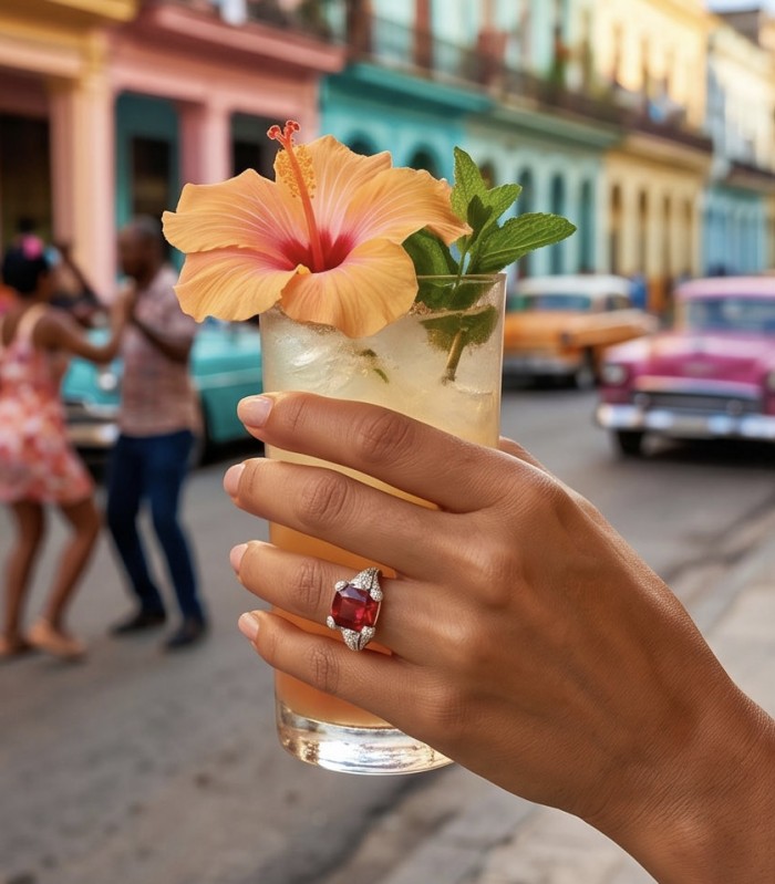 Scarlett 12.7 ctw Mozambique Ruby .925 Sterling Silver handcrafted Statement Ring size 8 - Ruby ring worn on hand holding a floral cocktail, vibrant street backdrop.