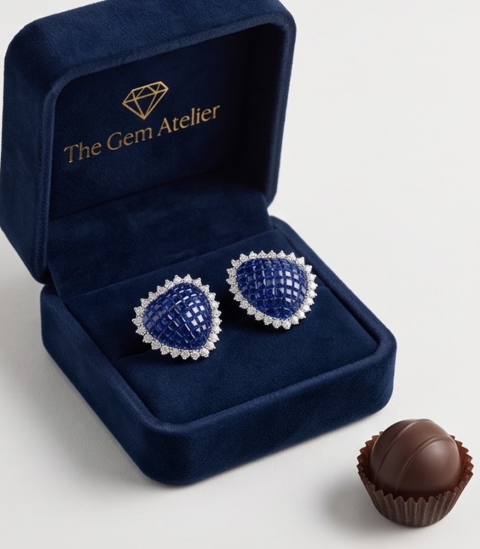 Precious Hearts mystery setting 11.8 carat Sapphire .925 Sterling Silver earrings - Earrings in a box with sapphire stones, front view, chocolate beside.