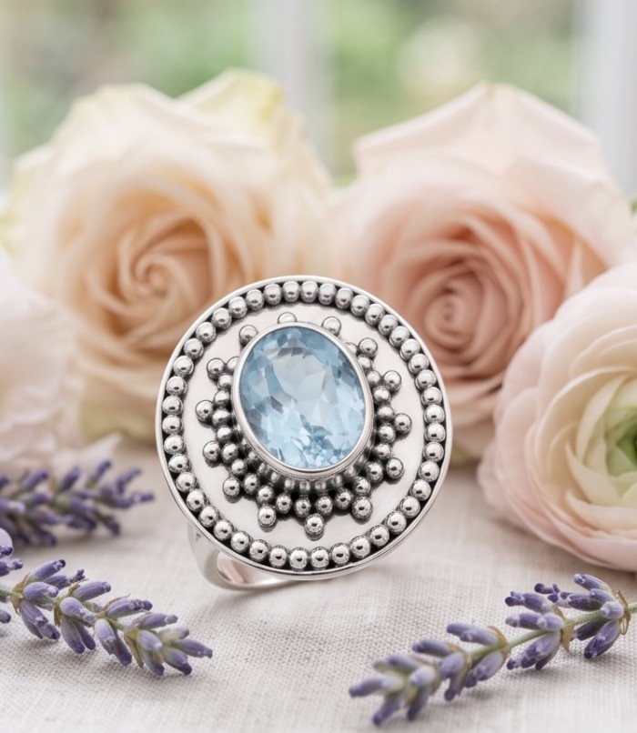 Atlantica 11.8 carat Swiss Blue Topaz .925 Sterling Silver dipped in rhodium handcrafted ring size 7 1/4 - Close-up of Atlantica ring with blue topaz and floral background