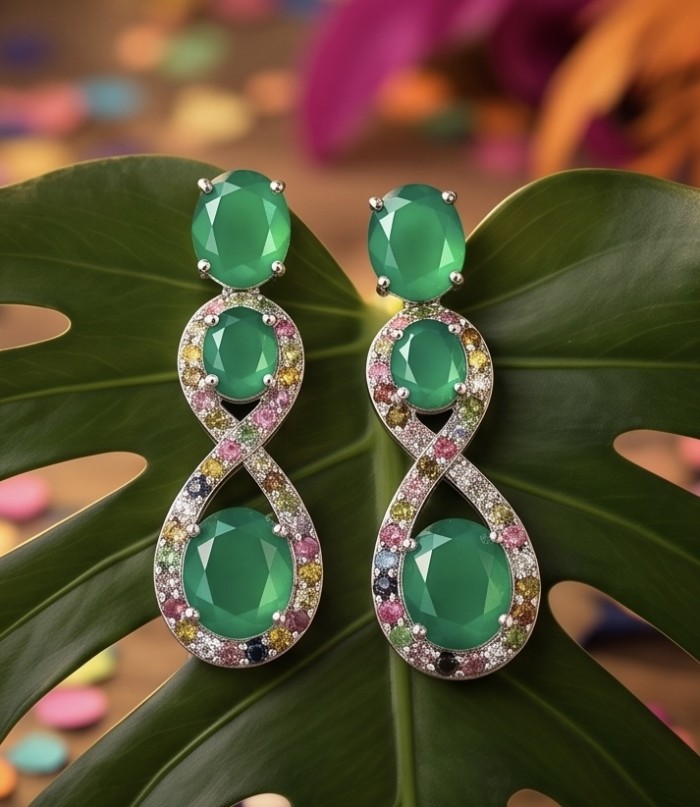 Enchanted Beauty 10.5 carat authentic Jade rhodium over .925 Sterling Silver handcrafted earrings - Front view of Enchanted Beauty jade earrings on a leaf background.