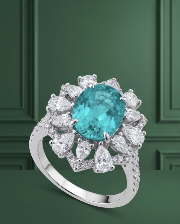 Elizabeth 6.4 carat Paraiba Tourmaline .925 Sterling Silver Handcrafted Ring size 5 - Paraiba tourmaline ring in silver, top view, against green background.