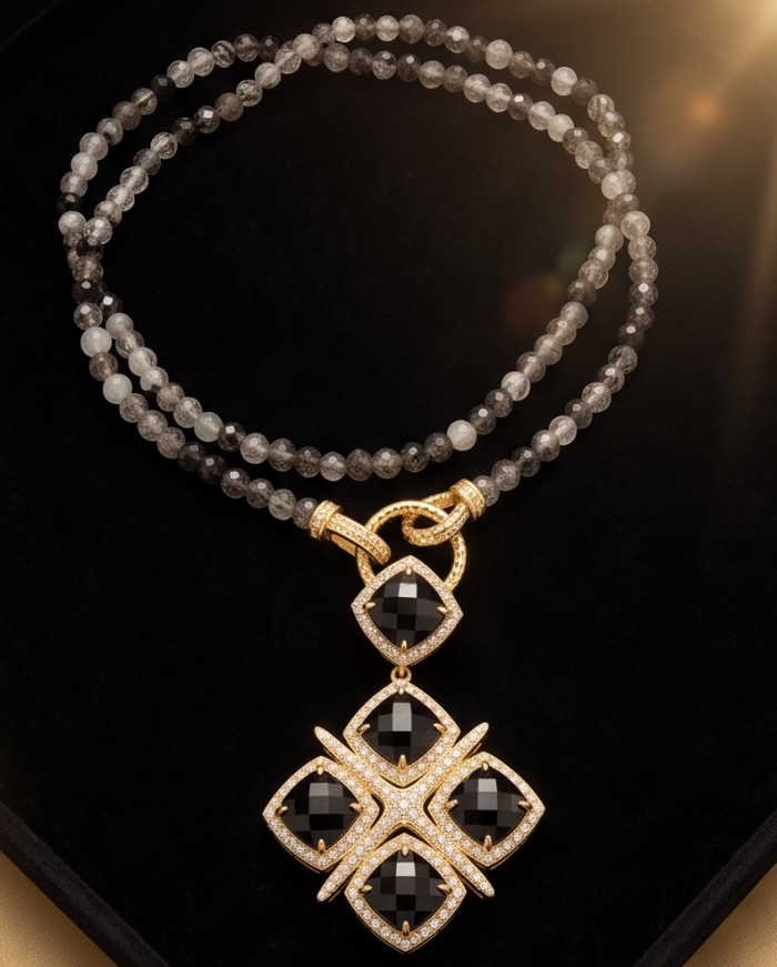 Authentic 25.2 Carat Onyx .925 Sterling Silver dipped in 14K Gold handcrafted necklace - Onyx and gold pendant with beads, close-up on black background.