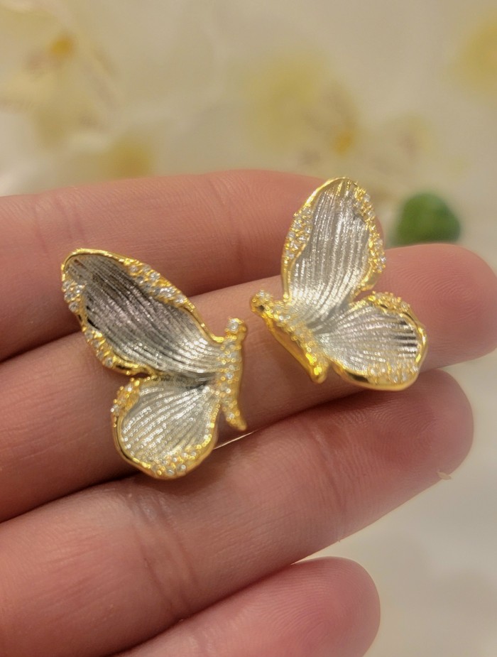 Golden Butterfly authentic 14k Gold over .925 Sterling Silver handcrafted earrings - Close-up of golden butterfly earrings on hand.