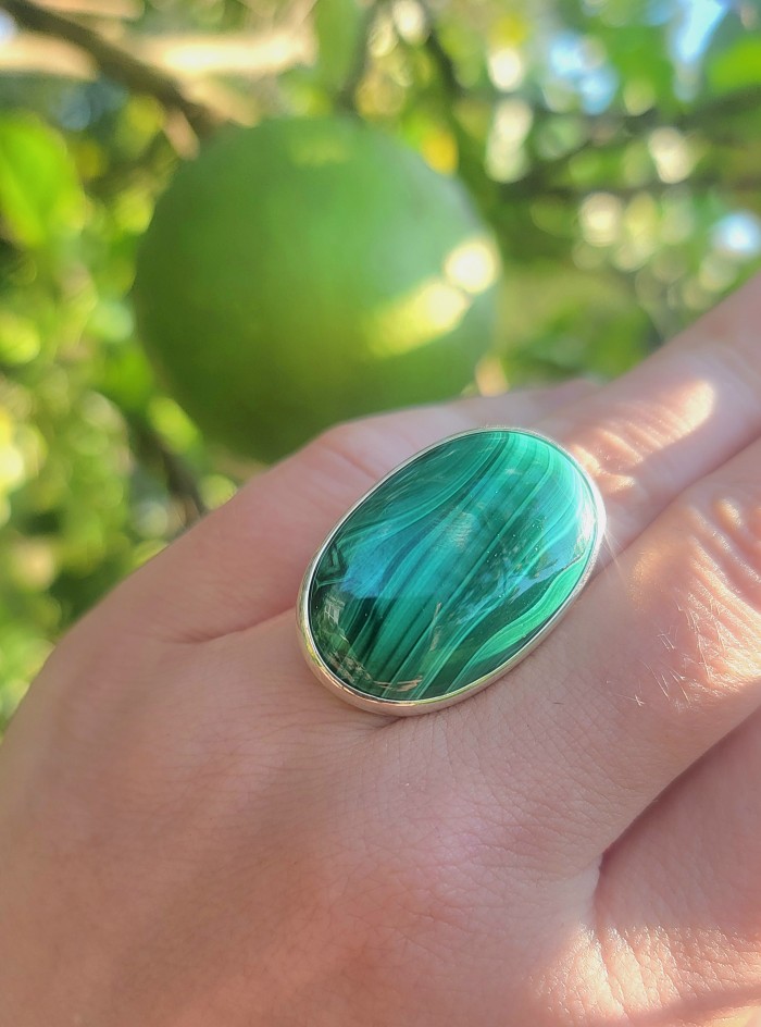 32.2 CARAT genuine Malachite .925 Sterling Silver handcrafted ring size 8 adjustable - Close-up of malachite ring worn on hand in natural light.